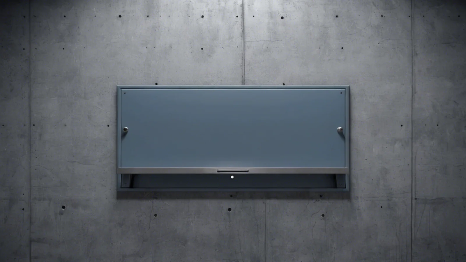 A wide grey steel panel set flush into a bare concrete wall with a dark open slot running the length of its lower edge, lit cold and flat, with no sign, plate or lettering anywhere on the panel or the wall.
