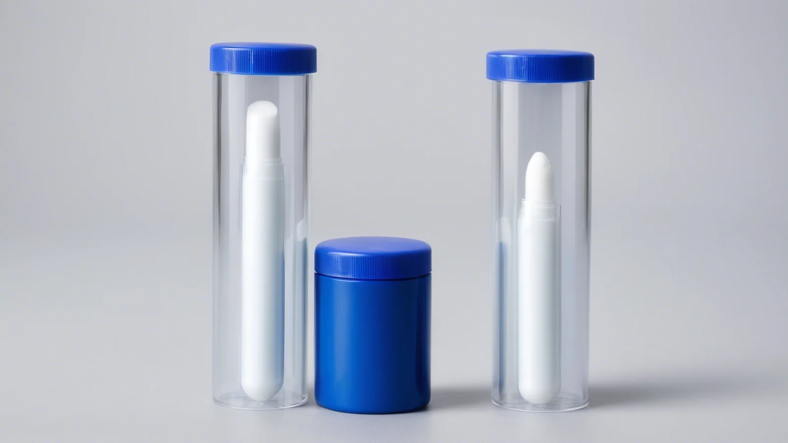 Two clear cylindrical containers holding white sample sticks, with plain blue caps and a smaller blue container between them.